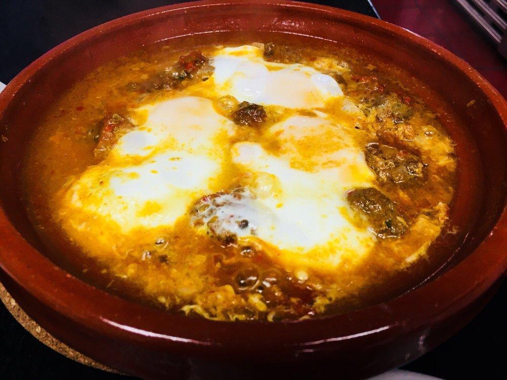 Shakshuka · Poached eggs, tomato sauce, chili peppers and onions served in tagine. Add mini Moroccan meatballs for an additional charge.