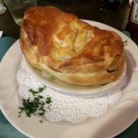 Chicken Pot Pie · Homemade with fresh chicken, mushrooms, peas, carrots, potatoes and pearl onion served in a ...