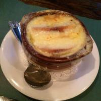 French Onion Soup · Served with a crouton and topped with Swiss mozzarella and grated Parmesan cheese.