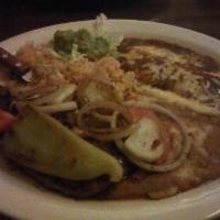 Carne Asada · Tender New York strip steak served with cheese enchilada served with refried beans, rice and...