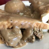 Meatloaf · 2 thick slabs of homemade meatloaf, topped with fresh brown gravy. Served with 2 sides and l...