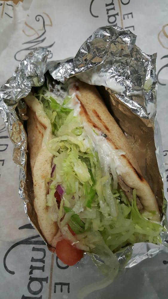 Gyro · Roasted beef and lamb on gyro bread with tzatziki sauce topped with lettuce, tomatoes and onions.