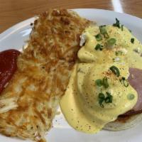 Eggs Benedict · English muffins topped with thick ham, poached eggs, green onions, smothered in Hollandaise ...