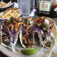 Fish Tacos · (3) Grilled mahi-mahi tacos with fresh cabbage, pico de gallo, and our special spicy mayonna...