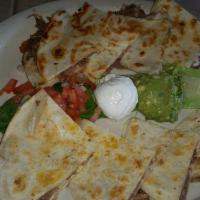 Quesadilla · Served with guacamole and sour cream. Choice of steak, chicken, carnitas, or brisket.