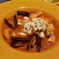 Cioppino · Savory Italian tomato stew with shrimp, fish, mussels, clams, calamari, and jumbo crab, acce...