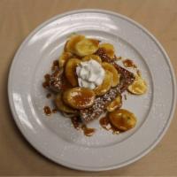 Caramelized Banana Crepes · 3 Crepes rolled with warm caramelized bananas topped with whipped cream and powder sugar