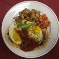 Huevos Rancheros · 2 eggs, refried beans, bacon, avocado, cheese, salsa and pico de gallo on corn tortillas.