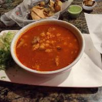 Pozole · Pork meat with hominy, served with cabage, cilantro and onions.
