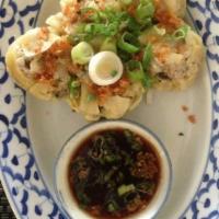 Steamed Dumplings · Crab and pork dumplings served with garlic sauce and soy sauce vinaigrette.