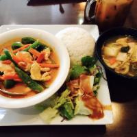 Panang Curry · Panang curry paste in coconut milk with bell peppers and sweet basil. Served with steamed ri...