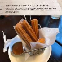 Churros · Fried dough pastry served with cinnamon, sugar, and dulce de leche.