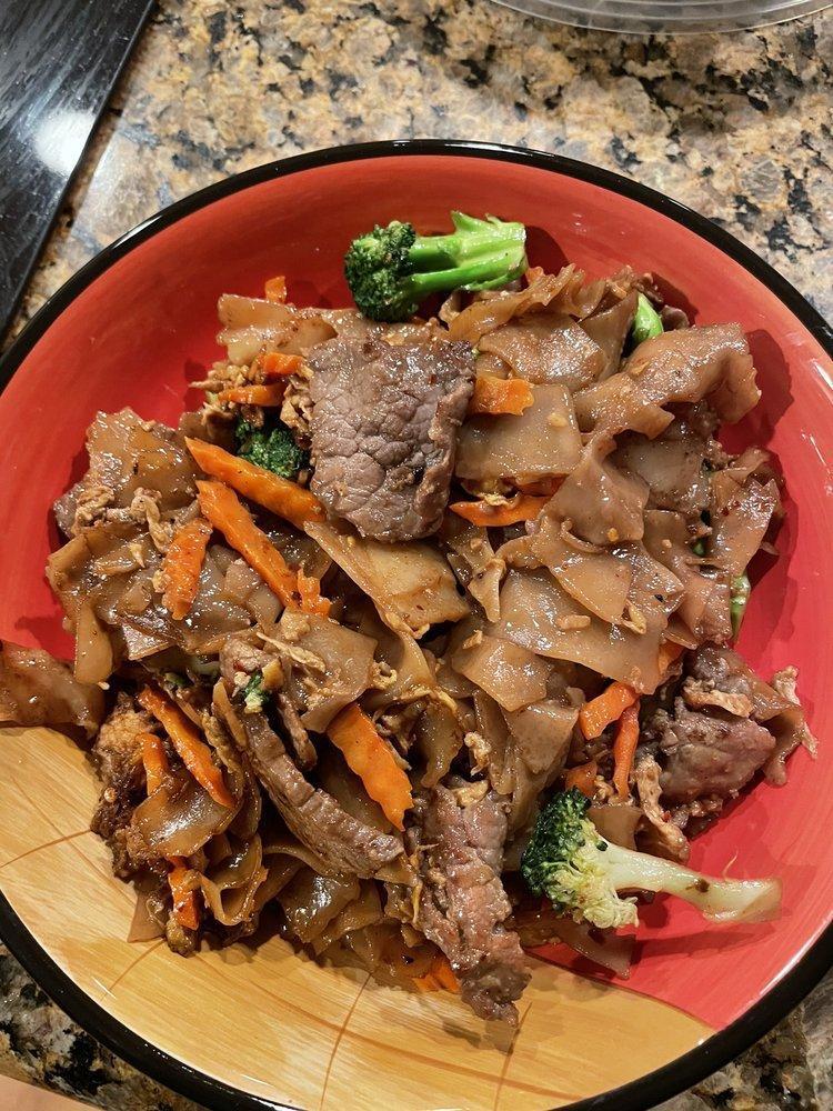 Pad See Ew · Wide rice noodles with garlic, egg, broccoli and carrots in a sweet black soy sauce.