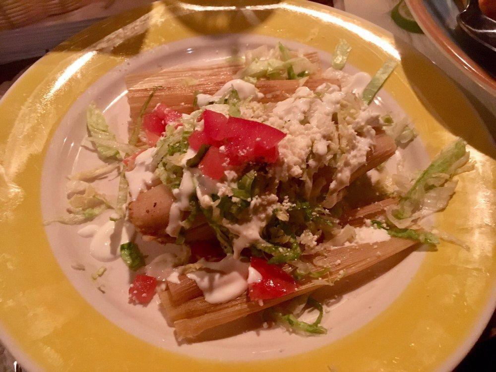 Tamales · Steamed cooked cornmeal dough stuff with with pork (red) or chicken (green).