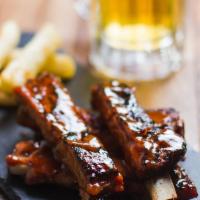 Baby Back Ribs · In a BBQ guava sauce. Served with fried yucca. Substitute french fries at no extra charge.