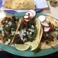 Al Pastor Taco · Marinated pork with grilled pineapple and onions. Tacos topped with fresh onions and cilantr...