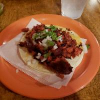 Chorizo Taco · Grilled traditional Mexican sausage, finished with freshly cut white onions and cilantro, li...