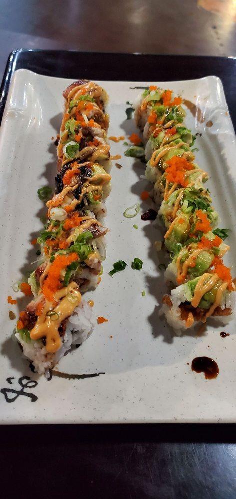 Tempura Shrimp Roll · House favorite. Tempura shrimp topped with avocado sauced in our sweet unagi glaze and spicy miso aioli with tobiko and green onions.