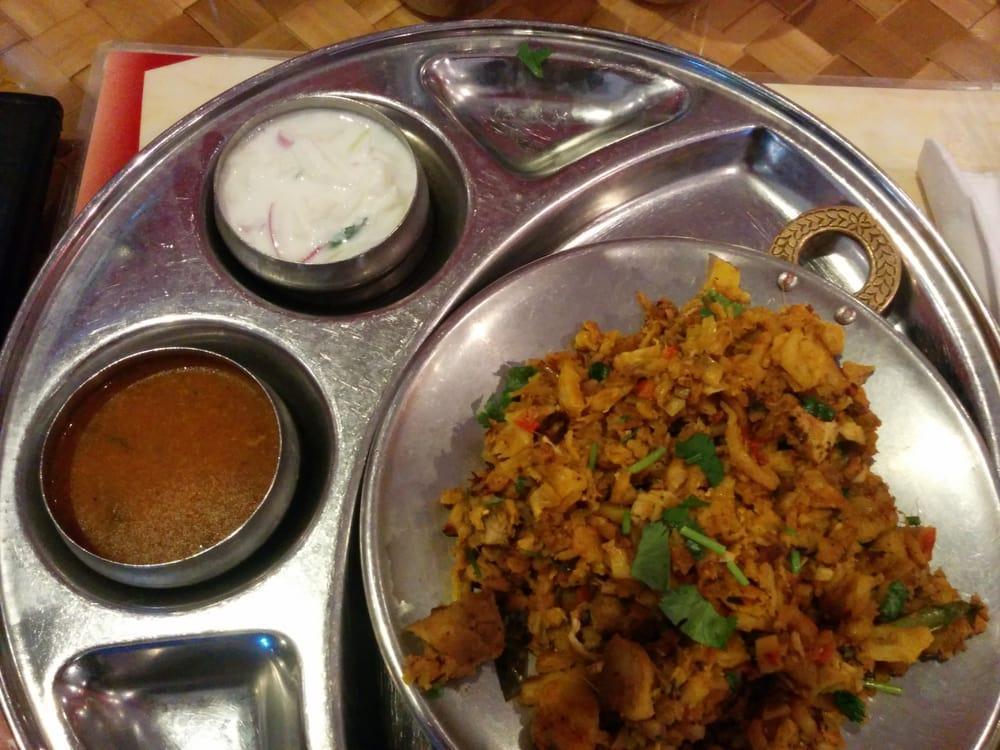 Chicken Kothu Parotta · South Indian parotta chopped and cooked with vegetables, onions, tomatoes. Comes with onion raitha and special curry. Spicy.
