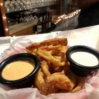 Dog Collars · Oven-baked beer-battered onion rings served with zesty horseradish sauce and ranch dip.