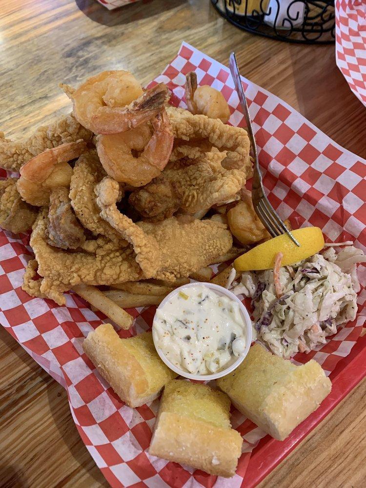 Seafood Platter · Large tail-on shrimp, strips of fried catfish and crispy fried oysters. Served with seasoned fries, hush puppies and coleslaw.