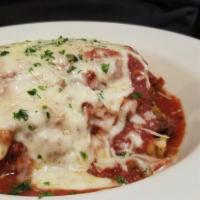 Lasagna · Layers of pasta shingled with meat, tomatoes, ricotta and mushrooms, smothered in mozzarella...