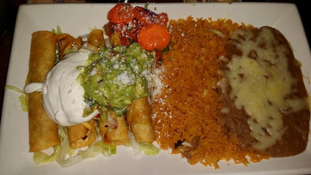 Flautas · Crispy taquitos filled with your choice of chicken, beef or cheese. Topped with lettuce, sour cream, guacamole, Cotija cheese, and tomato sauce. Served with rice and beans, pico de gallo, pickled carrots, and Cotija cheese.