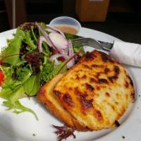 Croque Monsieur · Hot sandwich on white read with gruyere and ham coated with bechamel sauce. Served with a Fr...