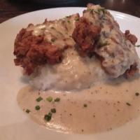 Country Fried Steak · Southern style country fried steak over scratch made mash potatoes, served with a side of ou...