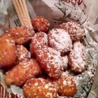 Corn Nuggets · Lightly fried, sweet creamed corn clusters topped with powdered sugar.