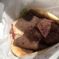 Gyro Wrap · Slices of gyro beef with tzatziki sauce, romaine lettuce, tomato, and sliced red onion. Wrap...