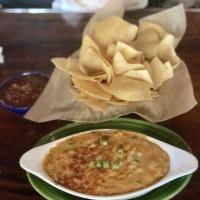 Queso · A creamy blend of cheese, tomatoes, roasted onions, jalapenos and topped with green onions. ...