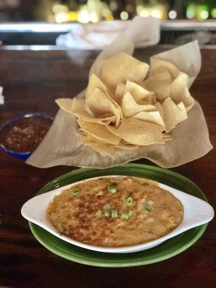 Queso · A creamy blend of cheese, tomatoes, roasted onions, jalapenos and topped with green onions. Enhance it with molida ground beef or chorizo for an additional charge.