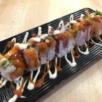 Godzilla Roll · Shrimp tempura and spicy tuna inside, topped with a variety of fish, masago, green onions, a...