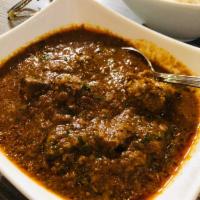Lamb Curry · Boneless lamb cooked in onion, tomato, ginger, garlic and mint spices.