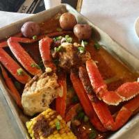 Snow Crabs · 2 Clusters.  Boiled snow crab clusters served with corn on the cob and potatoes.