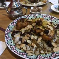 Mrouzia Almond Chicken · Slow braised chicken leg with caramelized onions, raisins, Moroccan spices and roasted almon...