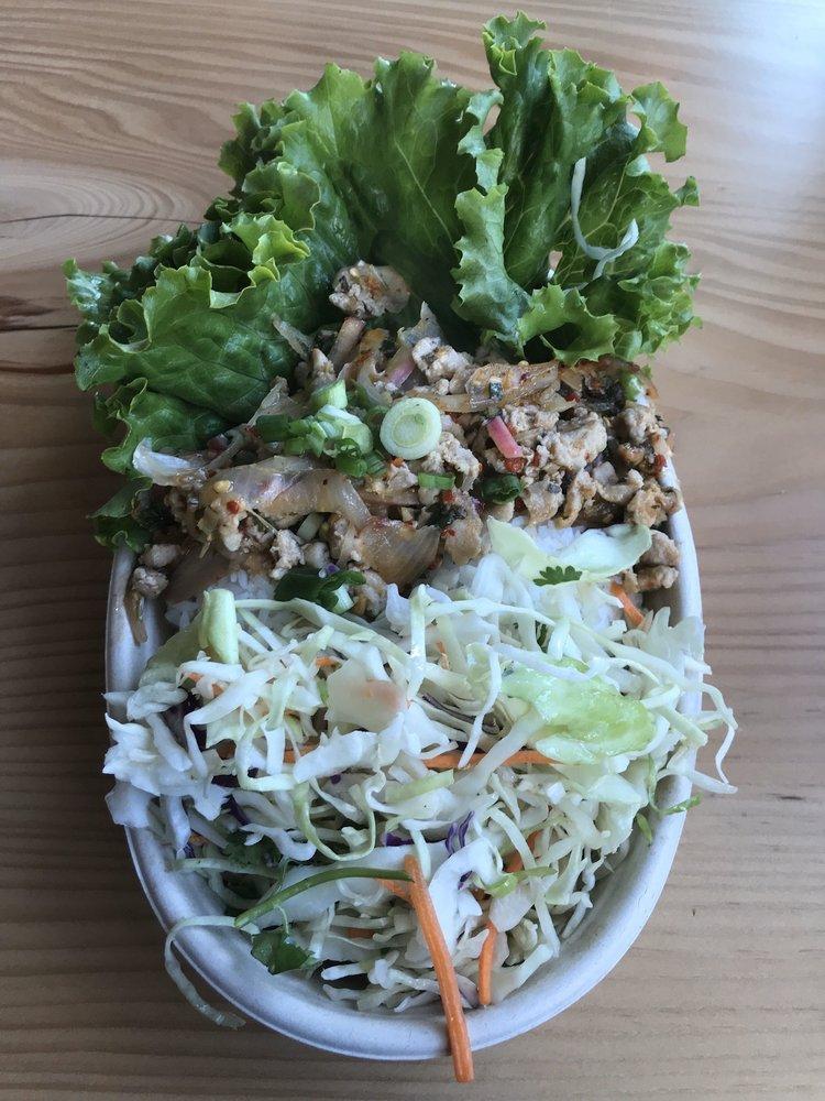 Larb Gai · Ground chicken, lemongrass, mint, cilantro, red onion, lime, and chilis. Served with two scoops rice, bib lettuce, and Asian slaw.