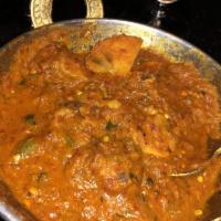Chicken Vindaloo · Chicken and potatoes in goan style, hot and tangy sauce. Served with basmati rice.