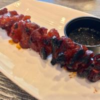 Pork BBQ Skewer · Grilled marinated pork skewer with special sauce.