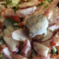 Falafel Salad · Falafel, lettuce, tomatoes, radish, parsley with tahini sauce and served with pita bread.