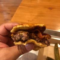 Holypeno Burger · Bacon, aged cheddar, jalapenos, caramelized onions, and chipotle mayo.