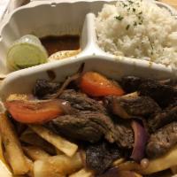 Lomo Saltado · Strips of prime sirloin sauteed in a special Peruvian sauce with onions, fresh tomatoes and ...