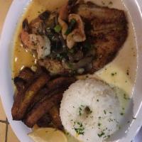 Tilapia · Pan fried tilapia topped with shrimp, mushrooms, spring oniosn, garlic, in a white wine sauc...