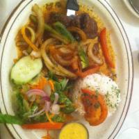 Bistec Encebollado · Tender marinated steak sauteed with onions, green peppers and tomatoes. Served with jasmine ...