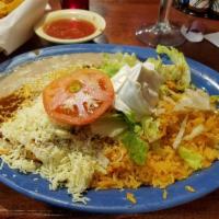 Burrito Amigos · A flour tortilla filled with seasoned ground beef or tender shredded chicken. Topped with re...
