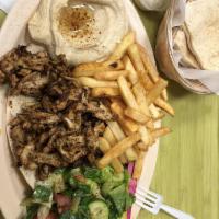 Beef Shawarma Plate · Filet mignon thinly sliced  comes with hummus, salad, rice and tahini sauce.