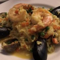 Paella · Clams, shrimp, mussels, scallops, calamari, green peas and rice in a saffron sauce.