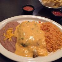 Chile Relleno · Poblano pepper stuffed with ground beef and cheese, lightly golden fried, topped with ranche...