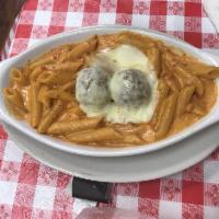 Baked Ziti with Meatballs · Penne pasta in pink sauce and meatballs baked with mozzarella cheese. Comes with garlic rolls.